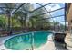 A refreshing enclosed pool area with patio seating and mature landscaping at 3237 Newmark Dr, Deltona, FL 32738