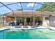The outdoor living space features a refreshing pool and a covered patio area at 3237 Newmark Dr, Deltona, FL 32738