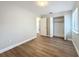 This bedroom features wood-look floors, light gray walls, a window, and a closet at 3322 Heather Glynn Dr, Mulberry, FL 33860