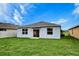 Spacious backyard featuring a lush lawn, sliding glass door, and a well-maintained exterior at 3354 Summerdale Way, Kissimmee, FL 34746