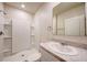 Clean bathroom with a single sink vanity, mirror, and a walk-in shower at 3354 Summerdale Way, Kissimmee, FL 34746