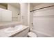 Clean bathroom with tub and shower, white tile, and sink with solid surface countertop at 3354 Summerdale Way, Kissimmee, FL 34746