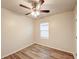Bedroom with wood-look floors, window view, and neutral color scheme at 3354 Summerdale Way, Kissimmee, FL 34746