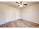 Spacious bedroom featuring wood-look flooring, ceiling fan, and neutral paint at 3354 Summerdale Way, Kissimmee, FL 34746