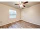 Bedroom featuring a large window and wood-look floors at 3354 Summerdale Way, Kissimmee, FL 34746