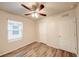 Bedroom features a ceiling fan, large window, and wood-look floors at 3354 Summerdale Way, Kissimmee, FL 34746