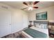 Cozy bedroom features a ceiling fan, modern decor, and a comfortable bed with stylish bedding at 3354 Summerdale Way, Kissimmee, FL 34746