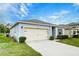 Charming home featuring a two-car garage, well-manicured landscaping, and a welcoming facade at 3354 Summerdale Way, Kissimmee, FL 34746