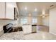 Modern kitchen featuring granite countertops, stainless steel appliances, and an open view to the living room at 3354 Summerdale Way, Kissimmee, FL 34746
