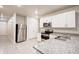 Well-equipped kitchen with stainless steel appliances, granite countertops, and ample cabinet space at 3354 Summerdale Way, Kissimmee, FL 34746