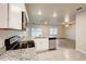 Modern kitchen featuring granite countertops, stainless steel appliances, and an open view to the living room at 3354 Summerdale Way, Kissimmee, FL 34746