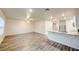 Bright living room with modern floors and a view of the kitchen with stainless steel appliances at 3354 Summerdale Way, Kissimmee, FL 34746