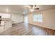 Open-concept living room with modern floors, ample natural light, and a view of the kitchen at 3354 Summerdale Way, Kissimmee, FL 34746