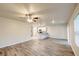 Bright living room featuring wood-look floors, and an open concept design to the kitchen and dining area at 3354 Summerdale Way, Kissimmee, FL 34746