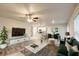 Stylish living room features modern decor, a ceiling fan, and an open concept design to the kitchen and dining area at 3354 Summerdale Way, Kissimmee, FL 34746