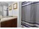 A full bathroom featuring a sink vanity with mirror and a shower with stylish curtain at 340 Pheasant Dr, Haines City, FL 33844