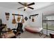 Well-lit bedroom features a ceiling fan, a large window, and guitars mounted on the wall at 340 Pheasant Dr, Haines City, FL 33844