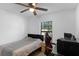 This bedroom features modern decor with a ceiling fan and a large window at 340 Pheasant Dr, Haines City, FL 33844