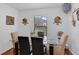 Cozy dining room with glass table, perfect for intimate meals and decorated with unique wall art at 340 Pheasant Dr, Haines City, FL 33844