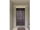 Close-up of a dark-brown front door with detailed trim and a decorative knocker, creating a welcoming entrance at 340 Pheasant Dr, Haines City, FL 33844