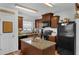 Well-lit kitchen with center island, dark appliances and wooden cabinets providing ample storage and counter space at 340 Pheasant Dr, Haines City, FL 33844