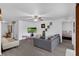 Bright living room with gray laminate flooring, featuring a ceiling fan and plenty of space for entertaining at 340 Pheasant Dr, Haines City, FL 33844