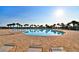 Beautiful community pool with palm trees and lounge chairs for relaxation at 340 Pheasant Dr, Haines City, FL 33844