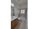 Bathroom with tiled flooring, a vanity sink, toilet, and tub with shower at 340 Sorrento Rd, Kissimmee, FL 34759