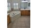 Corner tub in a bright bathroom with double vanities and shuttered windows at 340 Sorrento Rd, Kissimmee, FL 34759