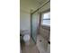 Bright shower stall bathroom with tiled walls and a white toilet at 340 Sorrento Rd, Kissimmee, FL 34759
