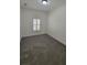 Bedroom featuring gray carpet, neutral walls, and a shuttered window at 340 Sorrento Rd, Kissimmee, FL 34759
