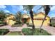 A yellow single Gathering home with a three-car garage, palm trees, and a brick driveway at 340 Sorrento Rd, Kissimmee, FL 34759