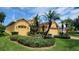 Lovely single-Gathering home showcasing mature landscaping, palm trees, and a spacious three-car garage at 340 Sorrento Rd, Kissimmee, FL 34759