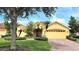 Charming single-story home with well-manicured lawn, mature palm trees, and a brick-paved driveway at 340 Sorrento Rd, Kissimmee, FL 34759