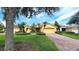Inviting single-story home with well-maintained landscaping and a brick-paved driveway at 340 Sorrento Rd, Kissimmee, FL 34759