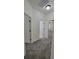 Bright hallway with gray carpet leading to doorways and interior doors at 340 Sorrento Rd, Kissimmee, FL 34759