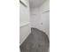 Well-lit hallway features neutral carpet, white walls, and doors for a clean, modern aesthetic at 340 Sorrento Rd, Kissimmee, FL 34759