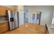 Open kitchen space with stainless steel refrigerator and view of screened patio at 340 Sorrento Rd, Kissimmee, FL 34759