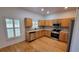 Bright kitchen features hardwood floors, stainless steel appliances and light-colored countertops at 340 Sorrento Rd, Kissimmee, FL 34759