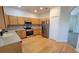 Well-equipped kitchen boasts stainless steel appliances, light quartz countertops and hardwood floors at 340 Sorrento Rd, Kissimmee, FL 34759