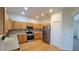 Well-lit kitchen with stainless steel appliances, light quartz countertops, and hardwood floors at 340 Sorrento Rd, Kissimmee, FL 34759