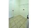 Functional laundry room with tile flooring, a wire shelf, and utility hookups at 340 Sorrento Rd, Kissimmee, FL 34759