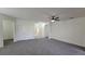 Neutral living room featuring neutral walls, carpeted flooring, and a front door at 340 Sorrento Rd, Kissimmee, FL 34759