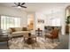 Bright living room featuring contemporary furnishings, neutral walls and large windows offering backyard views at 340 Sorrento Rd, Kissimmee, FL 34759
