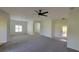 Open living room featuring neutral walls, carpeted flooring, and a light fixture at 340 Sorrento Rd, Kissimmee, FL 34759