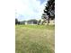 A spacious backyard featuring a screened-in lanai and lush green lawn at 3539 Maple Ridge Loop, Kissimmee, FL 34741