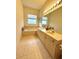 The main bathroom features a double vanity, garden tub, and tile flooring; ideal for relaxation at 3539 Maple Ridge Loop, Kissimmee, FL 34741