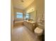The main bathroom features a large mirror, tiled flooring, bathtub, and toilet at 3539 Maple Ridge Loop, Kissimmee, FL 34741
