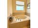 Relaxing bathtub with tile surround, perfect for unwinding after a long day at 3539 Maple Ridge Loop, Kissimmee, FL 34741