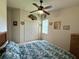 Bright bedroom with neutral tones features a ceiling fan, double closet, and comfortable bedding at 3539 Maple Ridge Loop, Kissimmee, FL 34741